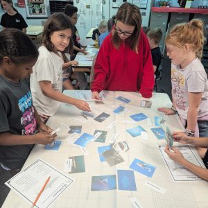 photo of kids looking at cards in marine camp